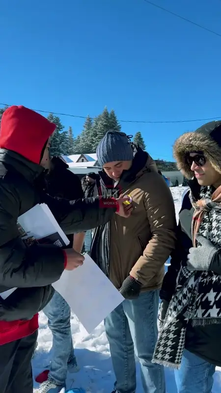 Participants reading task cards in a snowy field