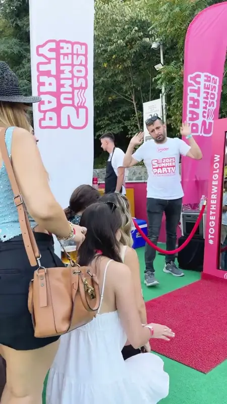 Guests queuing and posing in front of the mirror booth