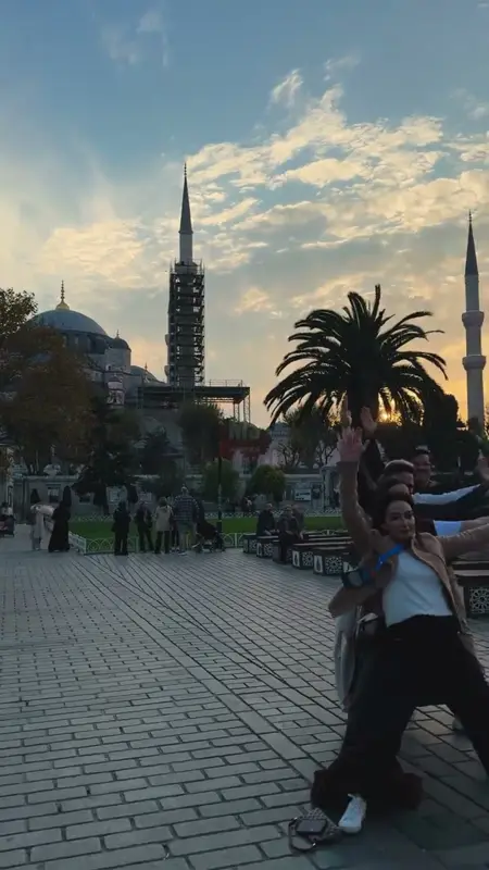 Team members posing in front of the Blue Mosque at sunset