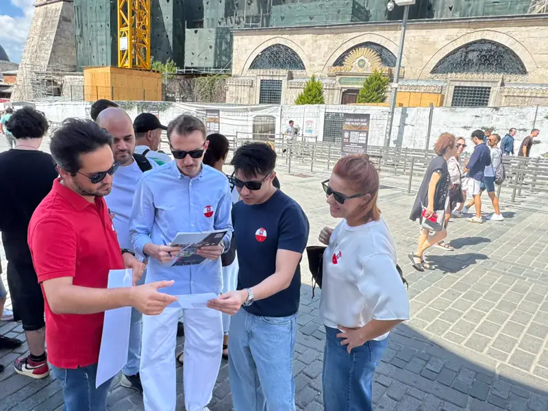 Sultanahmet'te Ayasofya önünde haritaya bakan treasure hunt takımı